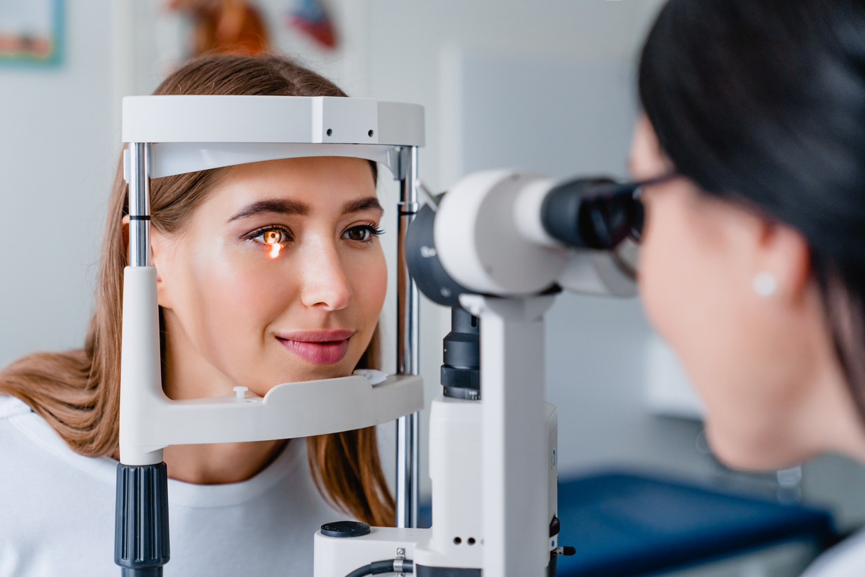 Eye doctor with female patient during an examination in modern clinic